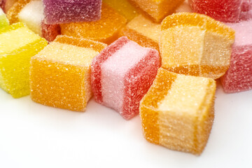 Colorful jelly candy mix white granulated sugar on white background