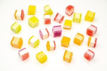 Colorful jelly candy mix white granulated sugar on white background