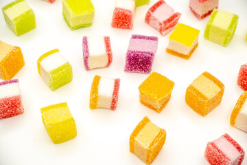 Colorful jelly candy mix white granulated sugar on white background