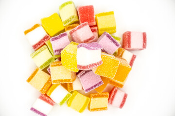 Colorful jelly candy mix white granulated sugar on white background