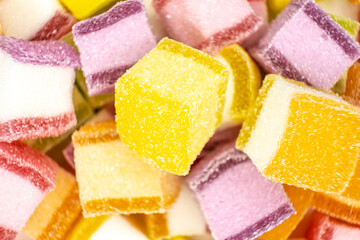 Colorful jelly candy mix white granulated sugar on white background