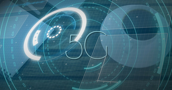 Image of scope scanning with 5g text and data processing over desk with laptop