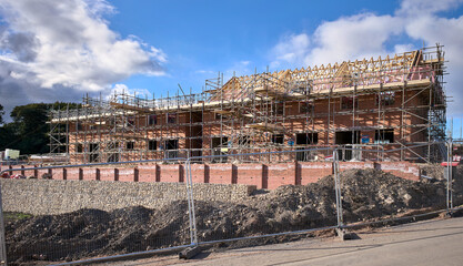 Fototapeta na wymiar New build homes being built in a housing development in a residential estate in Britain, UK.