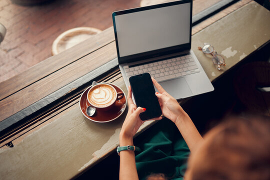 Phone, Laptop And Coffee Shop With A Woman Customer Browsing Social Media Or Texting From Above. Computer, Coffee And Email With A Female Consumer In An Internet Cafe For Communication Or Networking