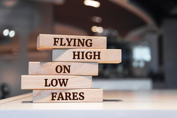 Wooden blocks with words 'Flying High on Low Fares'.