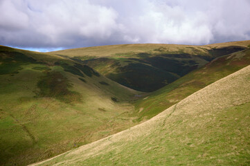 Naklejka premium Looking up Trows Burn below the summit of Windy Gyle in the Cheviot Hills in Northumberland, England, UK.