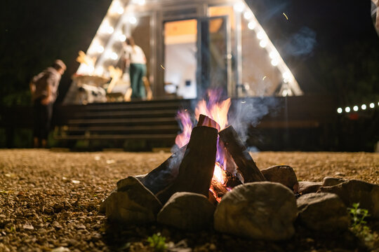 Campfire At Night With House And On Backyard, Close-up Shot Of Bonfire