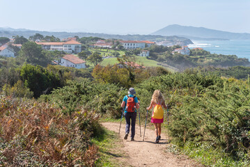 Two women walking along the Basque Coast. Saint Jean de Luz