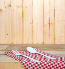 Obraz na płótnie Canvas tablecloth and spoon with fork for food serving background