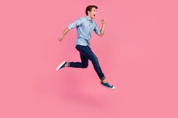 Fototapeta na wymiar Photo of crazy amazed guy jump up run fast rush surprise profile side isolated shine color background