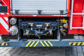 The back of the fire truck. Fire extinguishing valves, connectors and hoses.
