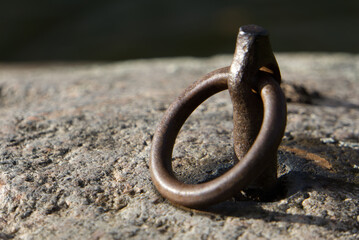 Metal ring in rock by the shore