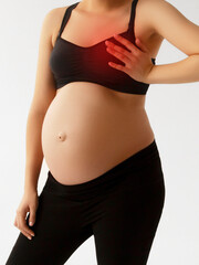 Closeup cropped portrait young woman with breast pain touching chest colored isolated on background