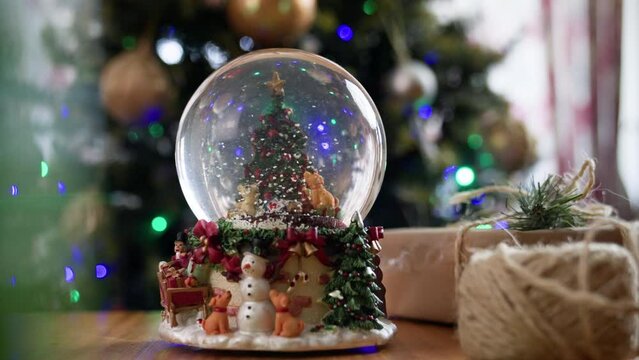 Christmas snowglobe with Christmas tree and snow falling inside 