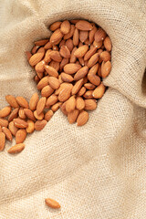 Roasted almonds on a sackcloth background give a natural feel