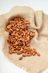 Roasted almonds on a sackcloth background give a natural feel