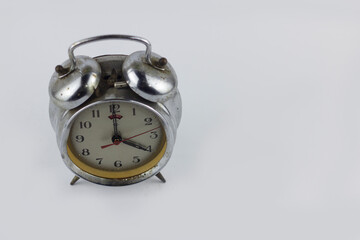 closeup classic clock alarm isolated at white background