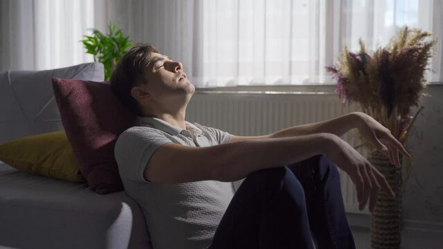 Close-up of depressed and frustrated man at home.
Stressed man at home tired and despondent.
