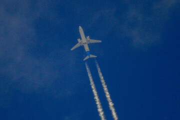 White passenger plane flying in the sky close-up