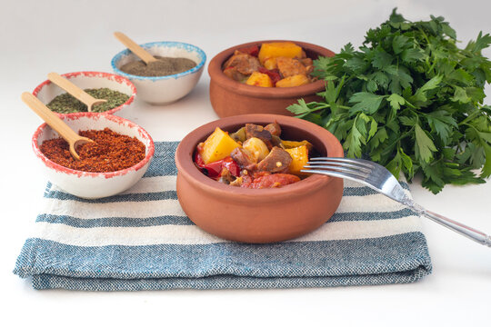 Top view of Turkish dish Guvech - baked meat with eggplant and traditionally served in earthenware pot (Turkish name; etli patlican guvec)