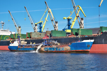 The dredge works in the port. Ventspils, Latvia.