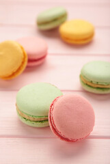 Fototapeta na wymiar Macarons on pink background. Sweet dessert