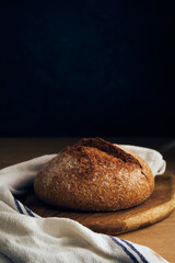 a loaf of bread on a wooden board
