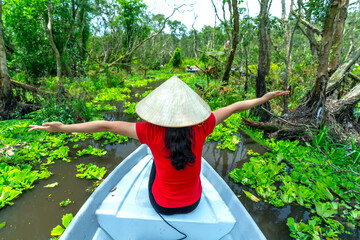 Traveler woman on a boat tour along the canals in the mangrove forest. This is an eco tourism area...
