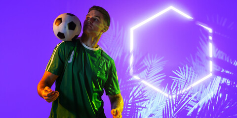 Caucasian player balancing ball on shoulder by illuminated plants and hexagon on purple background