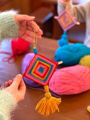 Children's creativity, a mandala made of colored yarn.