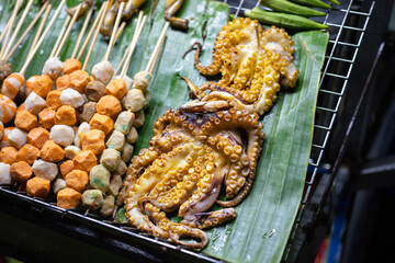Group of BBQ meat such as sliced beef, pork ball and sausage are selling on the stall at the street food market. Food object photo.