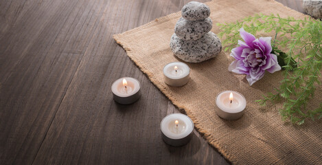 Spa aromatherapy concept. Decoration with candles, stones plants on wooden table