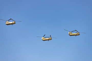 Helicopter. Airplane. Military vehicle. Spanish Air Force on the day of the National Holiday of October 12 flying over the streets of the city of Madrid. MADRID, SPAIN - OCTOBER 12, 2023