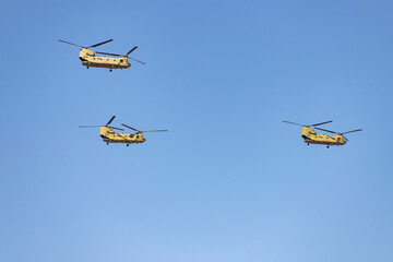 Helicopter. Airplane. Military vehicle. Spanish Air Force on the day of the National Holiday of October 12 flying over the streets of the city of Madrid. MADRID, SPAIN - OCTOBER 12, 2023