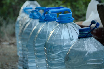 Recycled water bottles with rainwater.
Save water. Concept of global warming and drought in the...