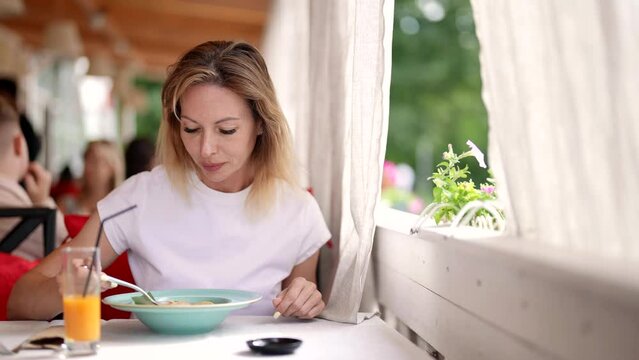 woman having lunch in restaurant, eating delicious soup, tasty food and healthy nutrition
