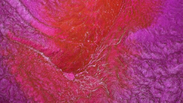 Fluid art drawing, abstract acrylic texture with colorful waves. Abstract background of water ripples, marble. Glitter in the flowing pink paint.