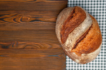 Homemade freshly baked bread. Wood rustic table, board. Rural food cooking. Top view