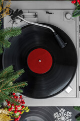 Turntable Vinyl records, Christmas party music, New Year events, fir branches, top view. Empty copy...