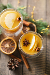 Hot apple cider with cinnamon sticks, apple and holiday christmas decoration. Top view