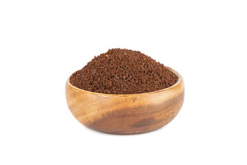 Ground coffee in a wooden bowl over a white background.