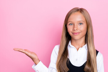 Photo of lovely cute girl stand empty space arm show cool product stylish clothes low price sale shopping isolated on pink color background