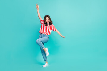 Fototapeta na wymiar Full length photo of cheerful lovely cute lady eyes closed dancing empty space dressed trendy clothes isolated on cyan color background