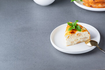 Baked Sweet Cottage Cheese casserole with apple decorated mint. Copy space