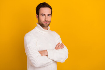 Photo of confident well-groomed masculine guy folded arms posing wear white sweater isolated yellow color background