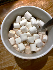 top view of a grey mug with hot chocolate and marshmallows