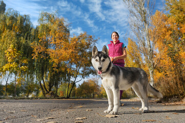 Portrait of a woman and her husky dog at the walk