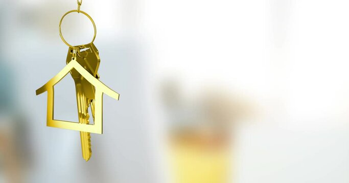 Animation of gold house key fob and key dangling over out of focus interiors with copy space