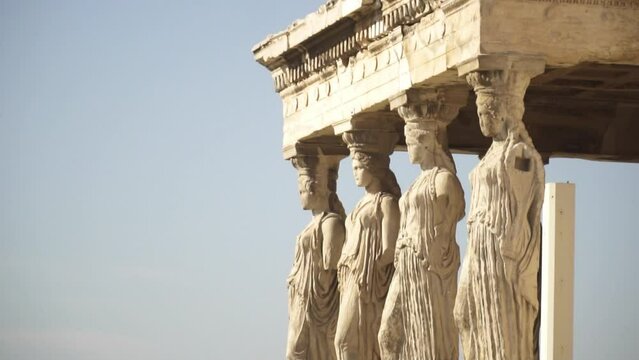 Close view of the outer statues of Cariátides and Acropolis in Athens Greece