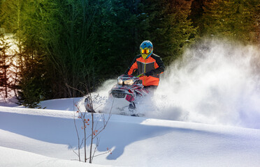 snowmobile fun. sports snow bike with snow splashes and snow trail. bright snowmobile and suit without brands. snowmobilers sports riding. stock photo very high quality